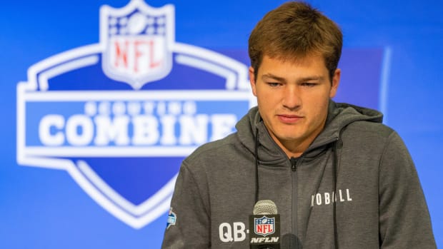 Drake Maye stands at a microphone at the combine